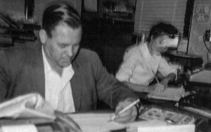 E.I. Logan working in the office