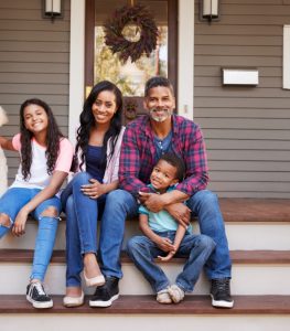 Happy Family on front steps of their house