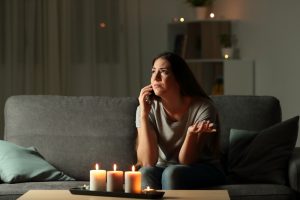 Lady on the phone with the electric company during a blackout