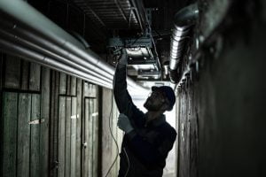 Silhouette of an electrican installing lights