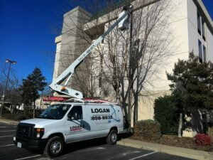 Logan Electric Service Bucket truck working on a local hotel pole light